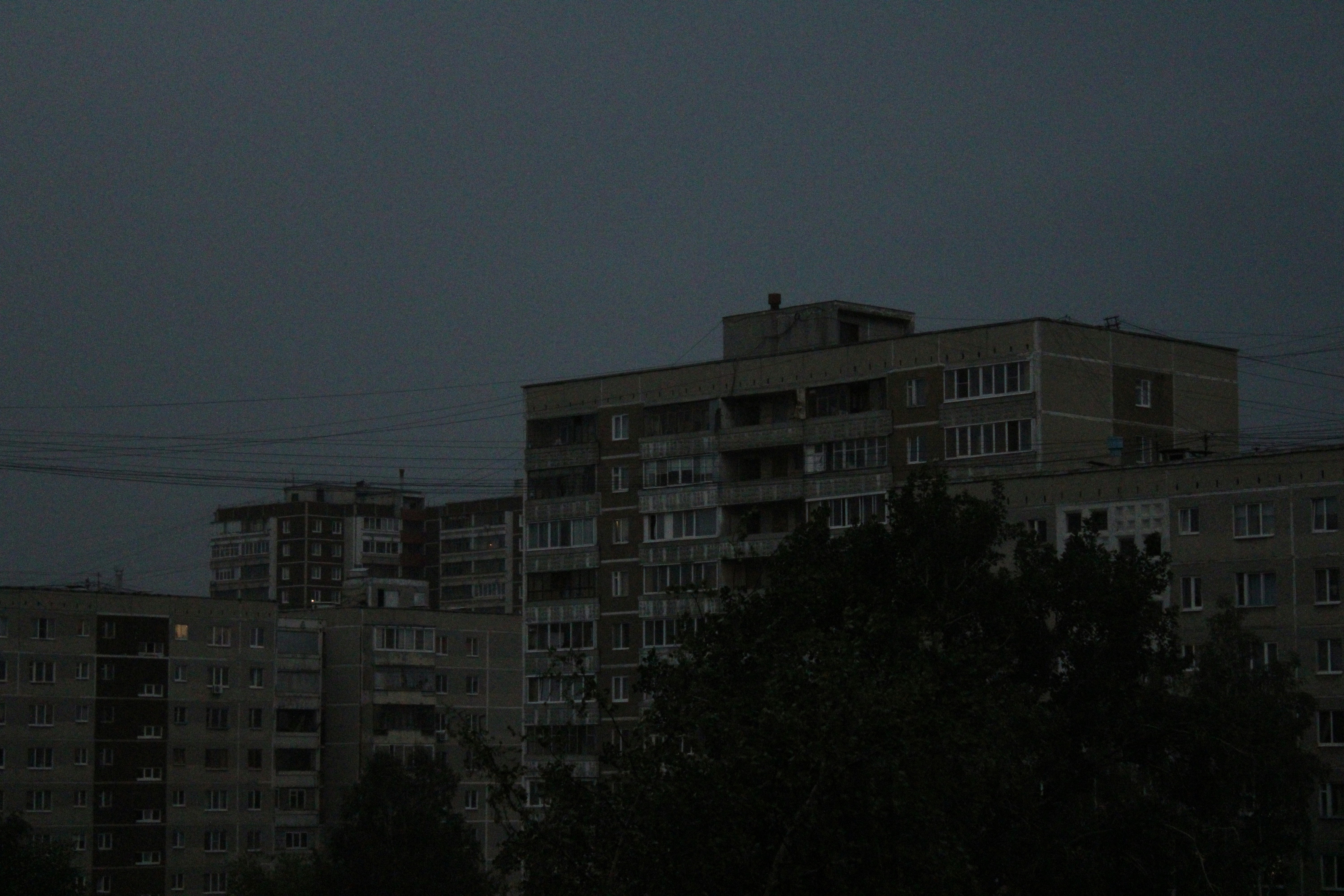 a full moon in the sky over a city