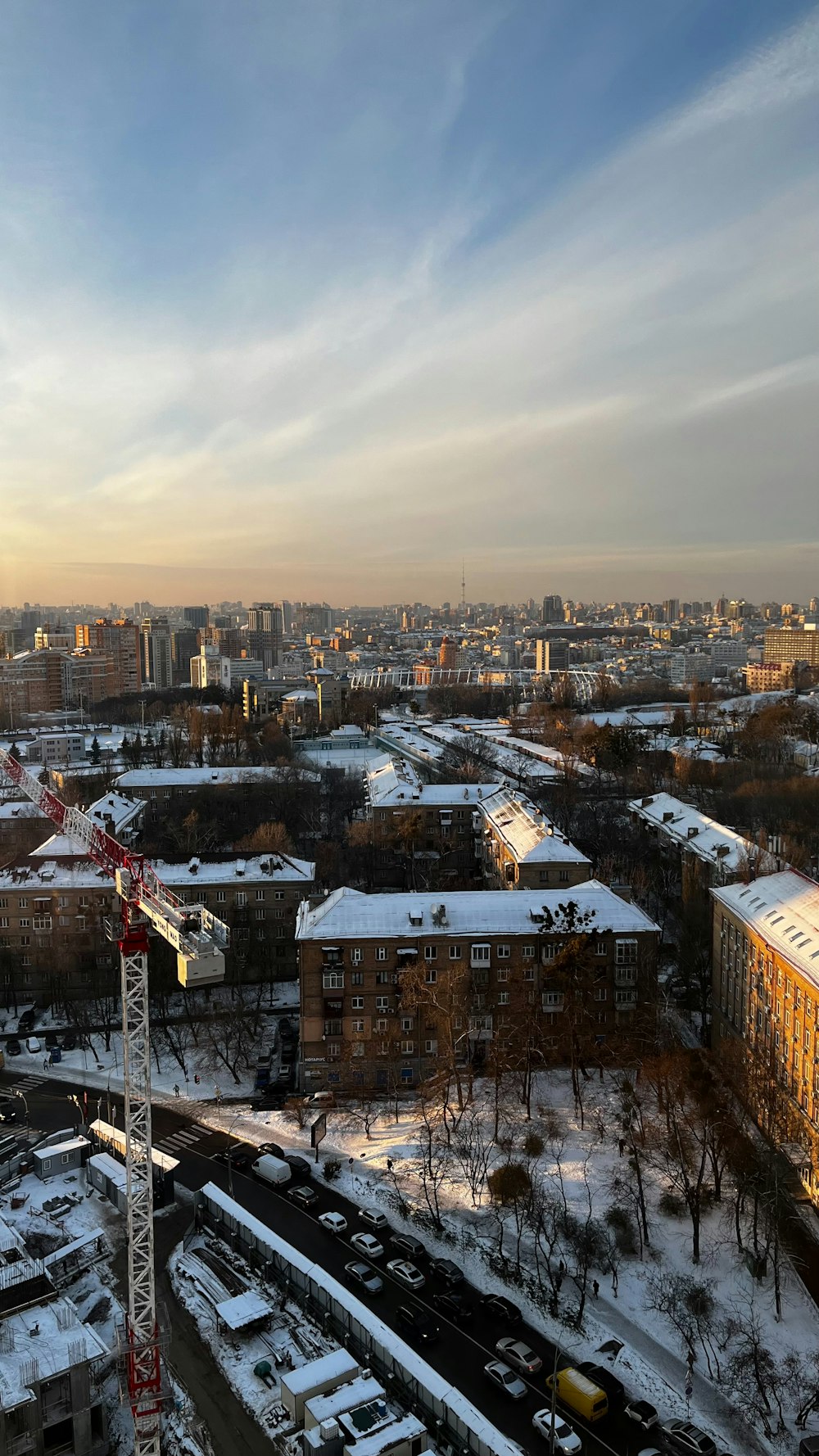 a view of a city with a crane in the foreground