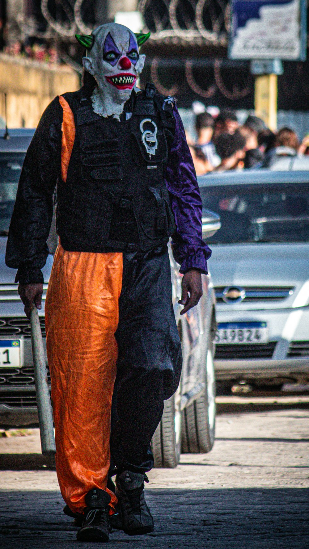 a man dressed as a clown walking down a street