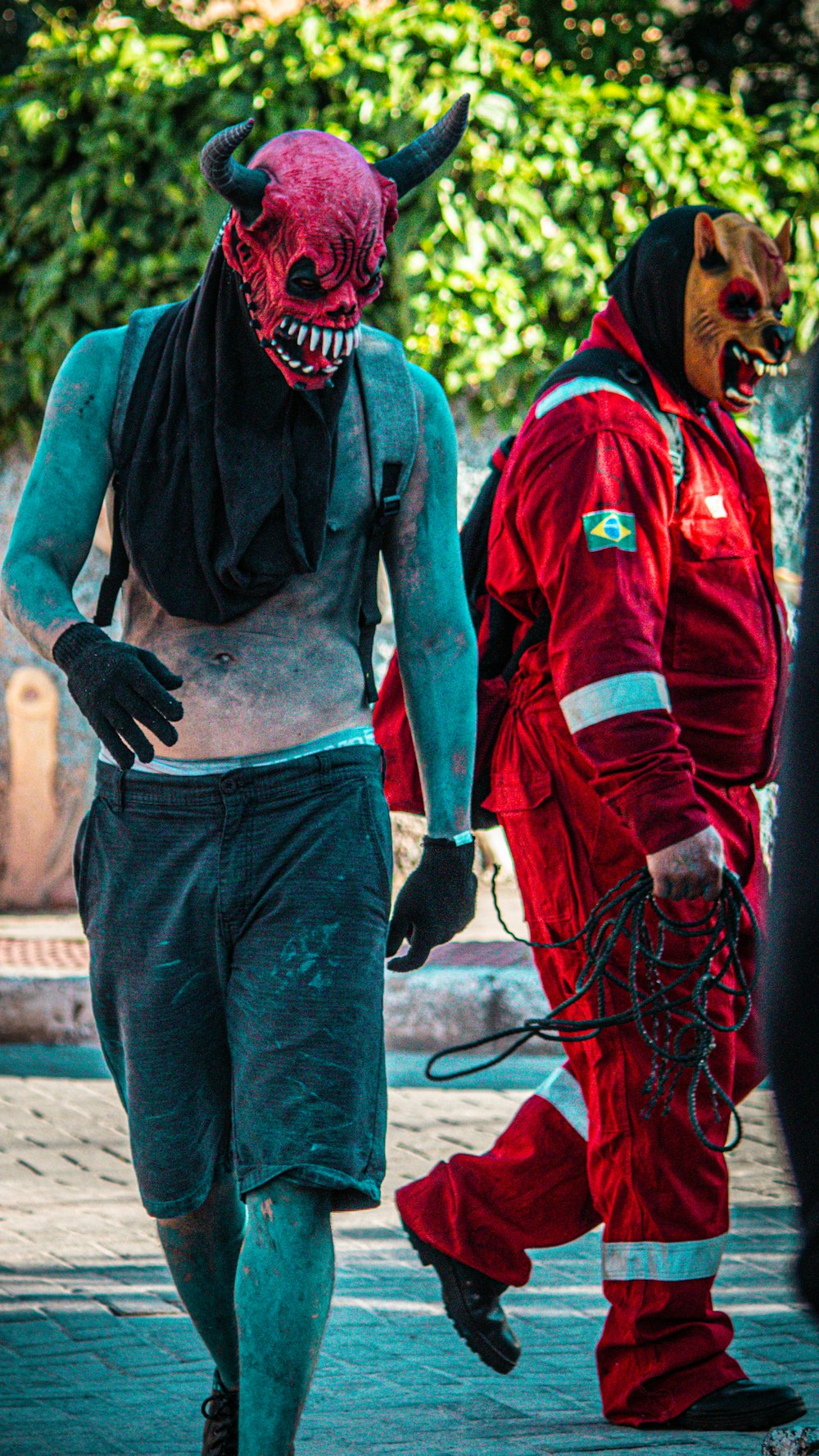 a couple of men in costumes walking down a street