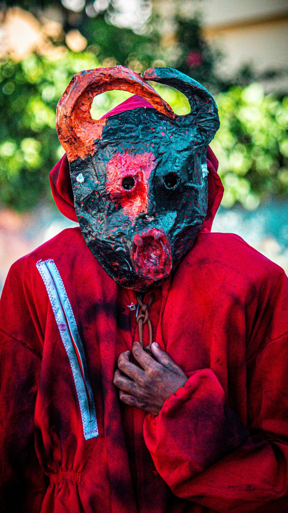 a person wearing a mask and a red jacket