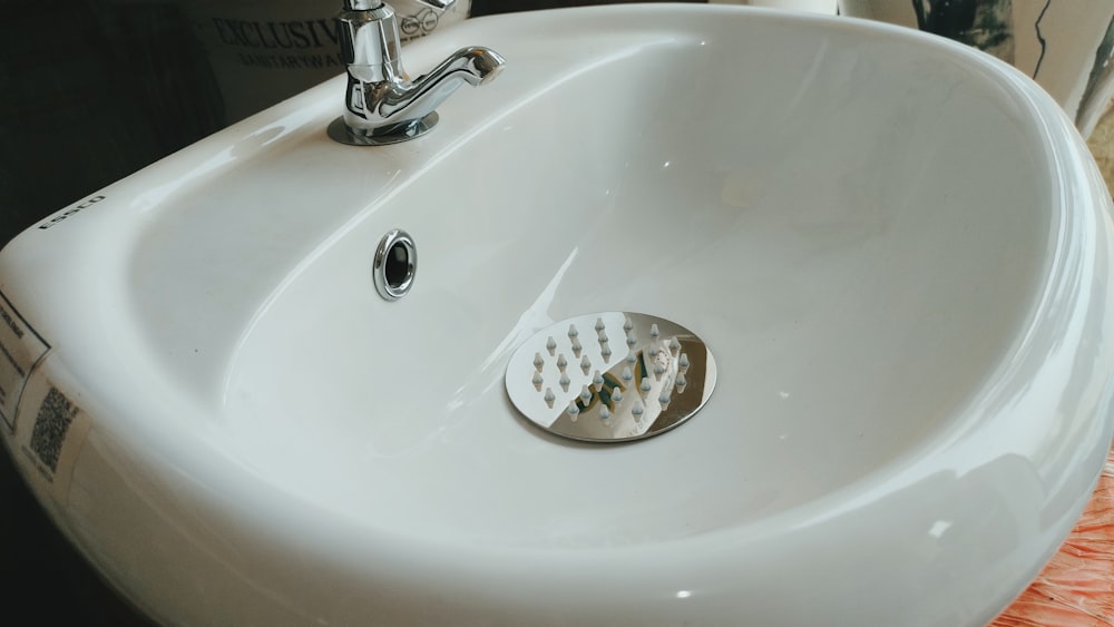 a bathroom sink with a drain running from the faucet