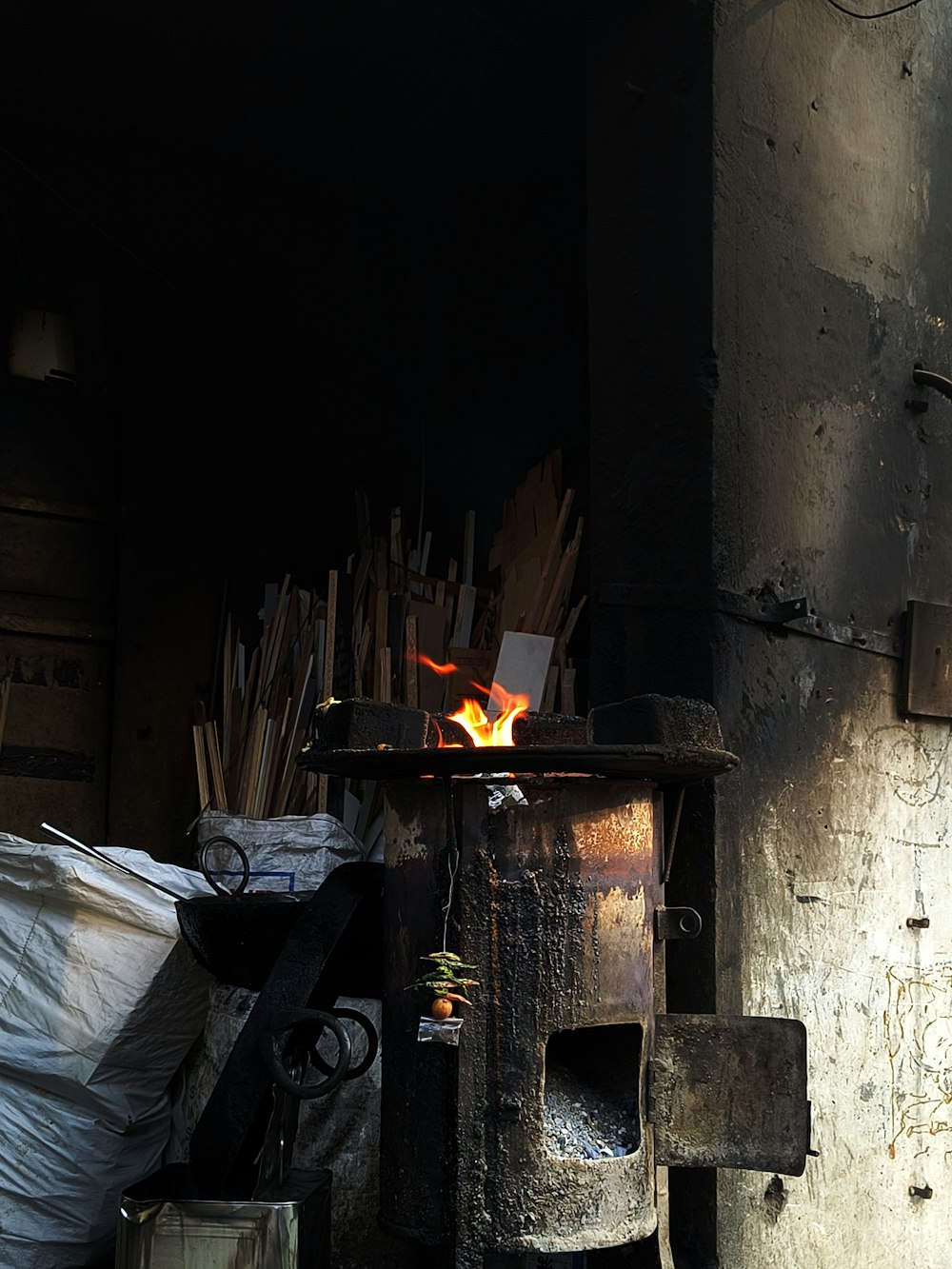 a fire burning inside of a metal oven