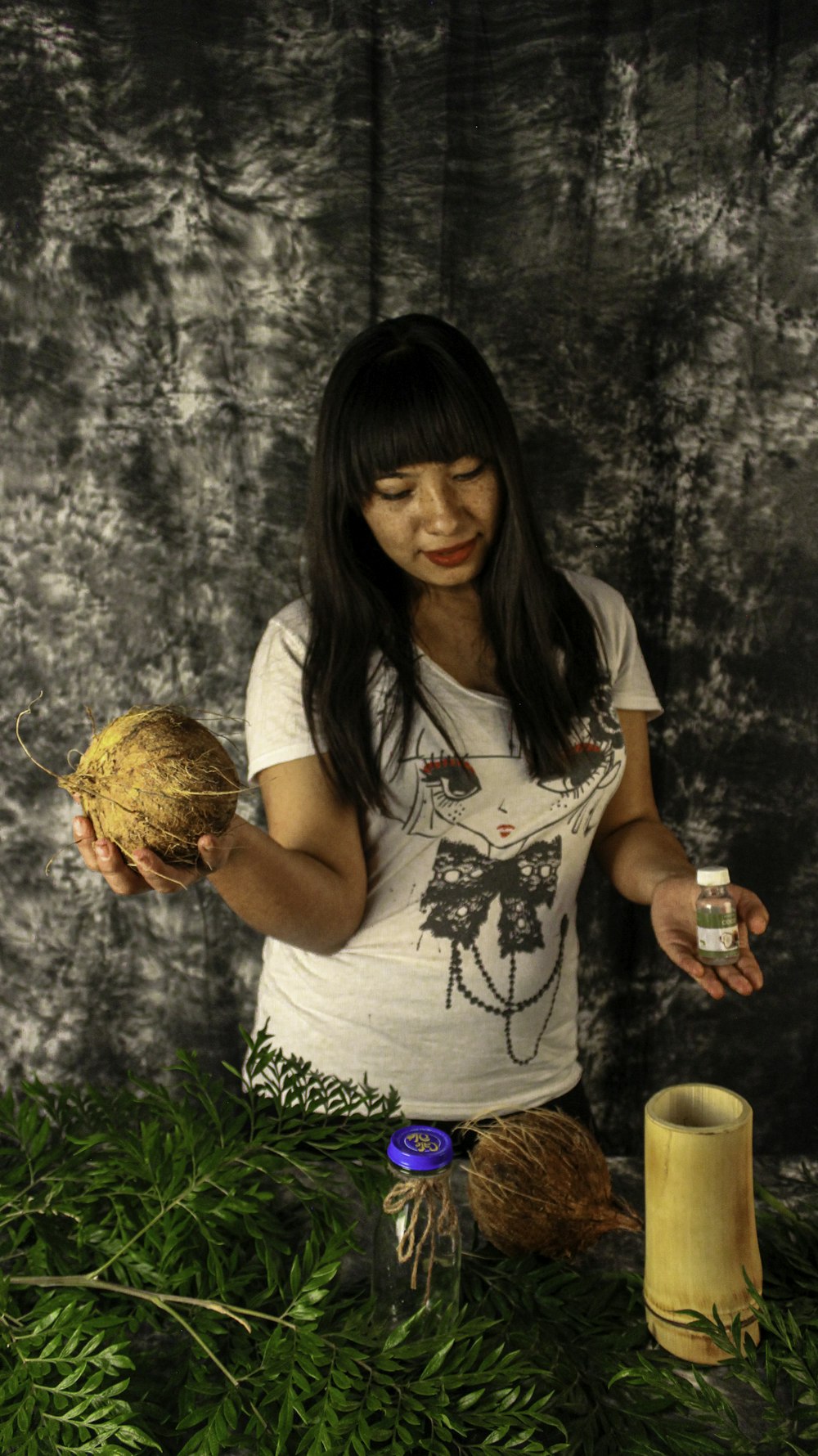 a woman holding a coconut in her hands