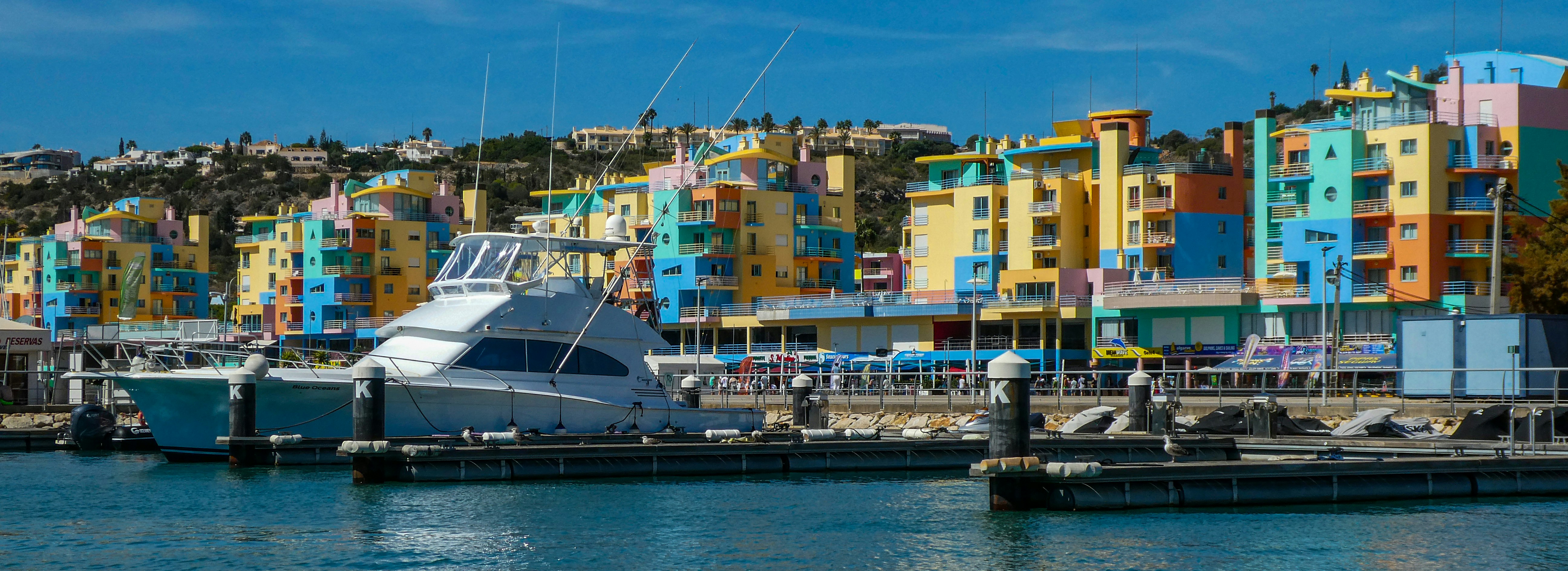 a boat docked in a harbor next to colorful buildings