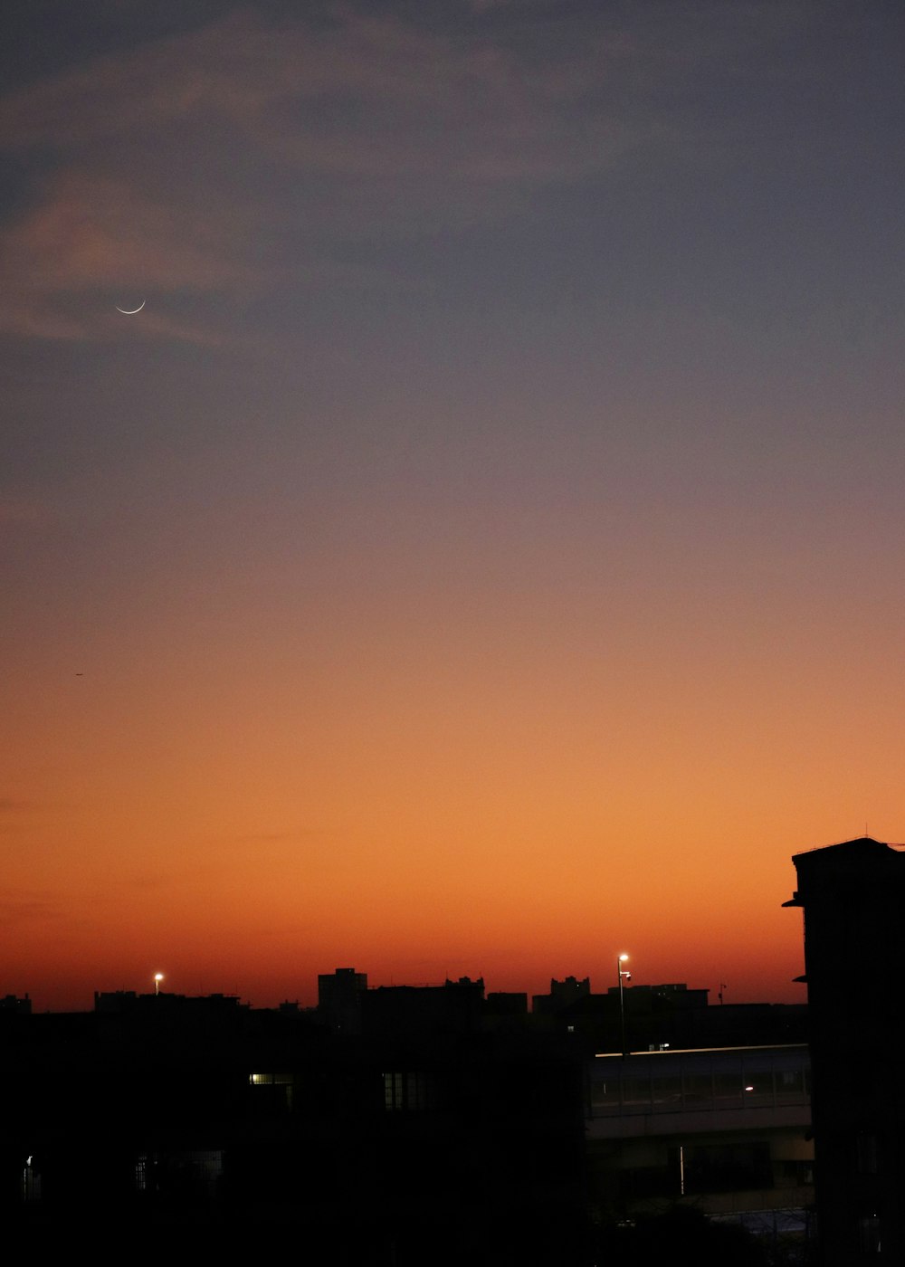 a plane is flying in the sky at sunset