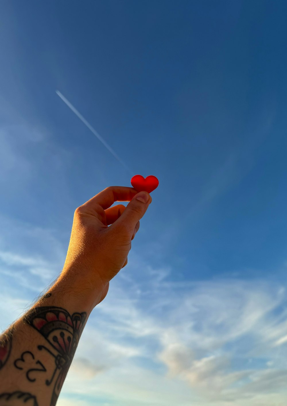 a person holding a red object in their hand