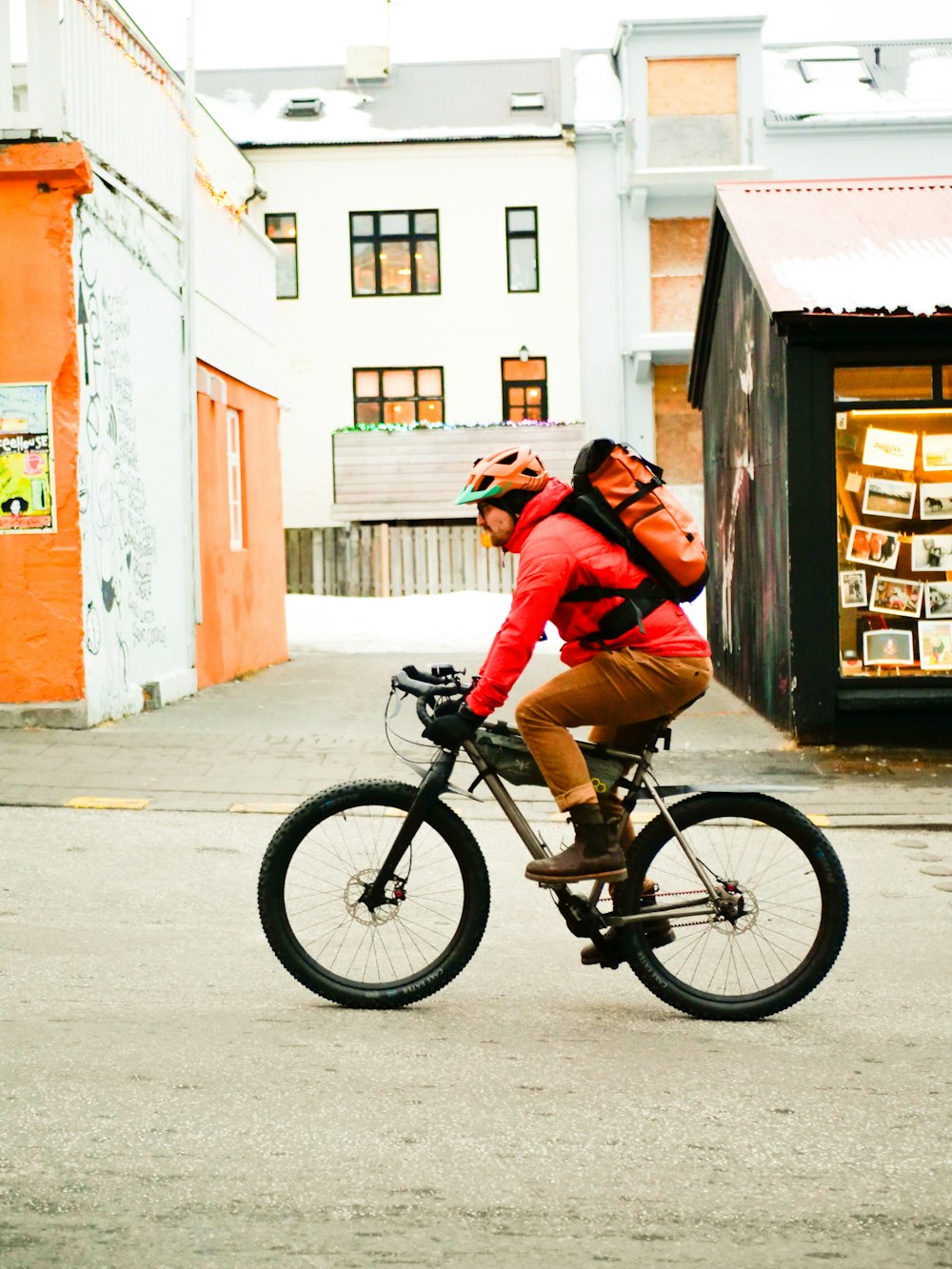 a man riding a bike down a street