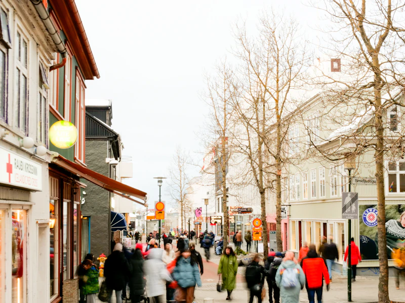 People walking along an old Reykjavík street in winter layers