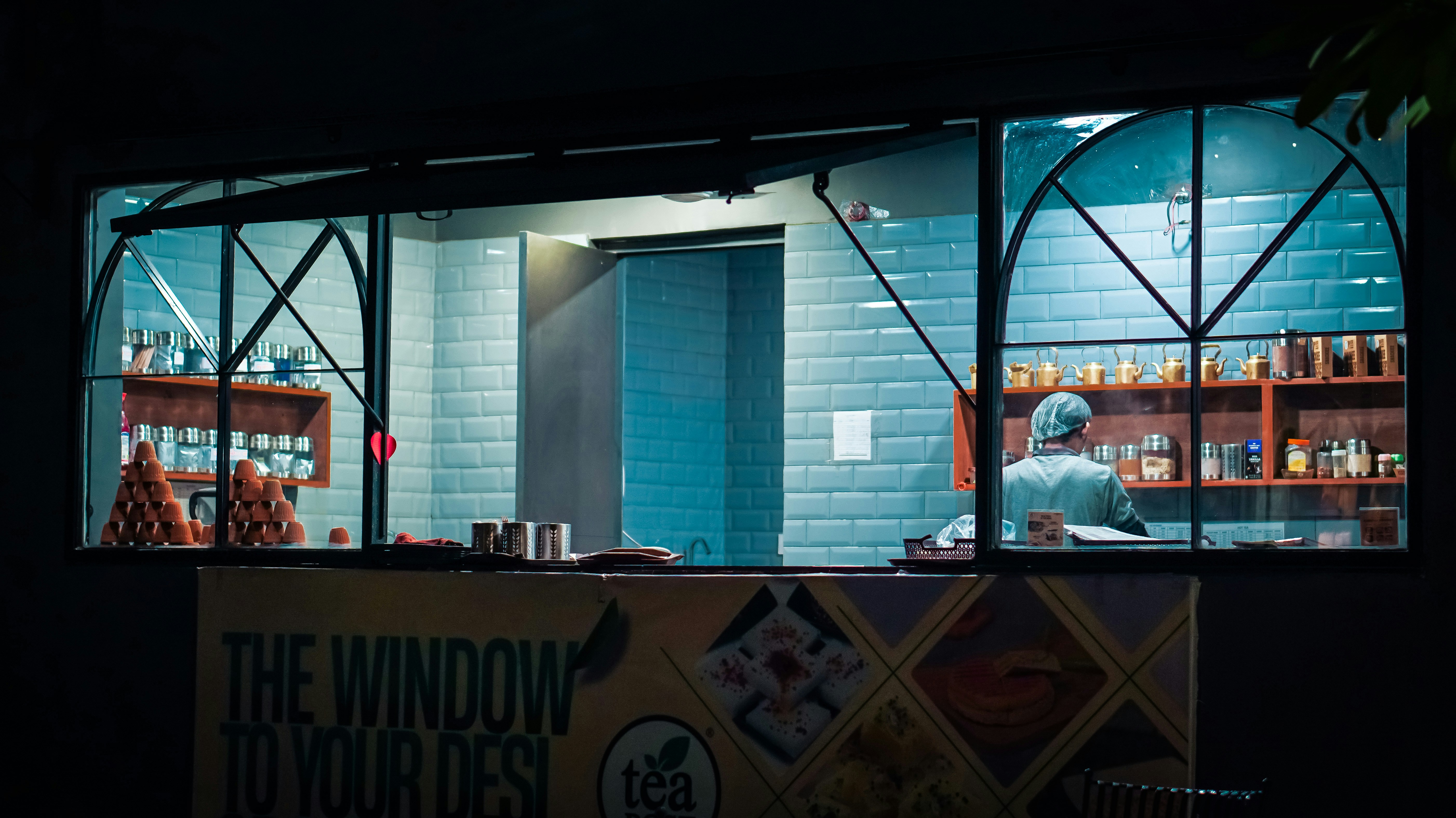 a restaurant window with a person behind it