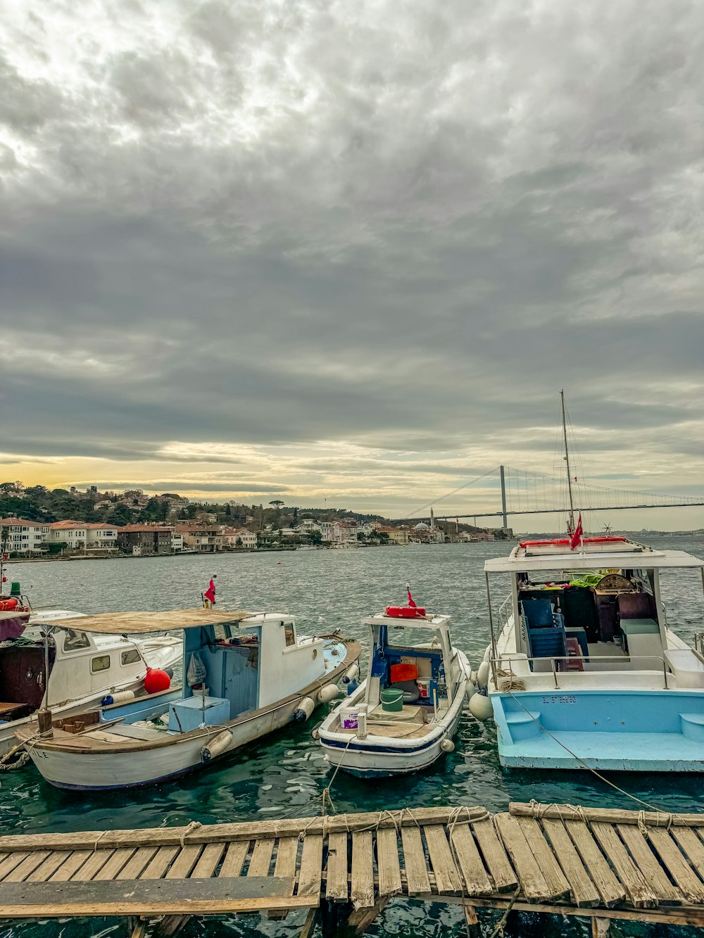 a group of boats docked at a pier