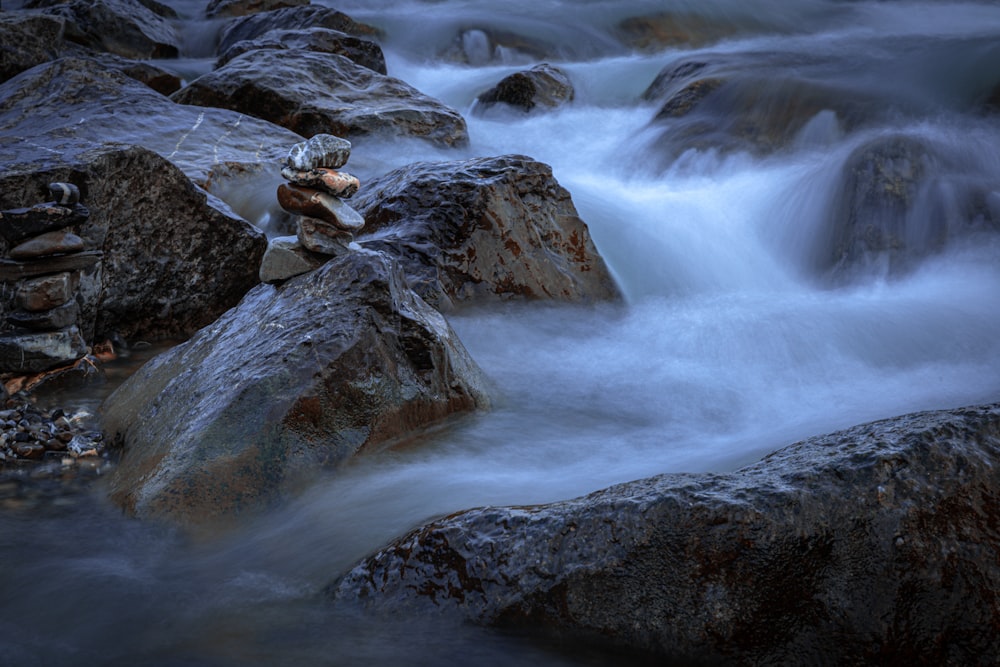 a stream of water running over rocks in a river