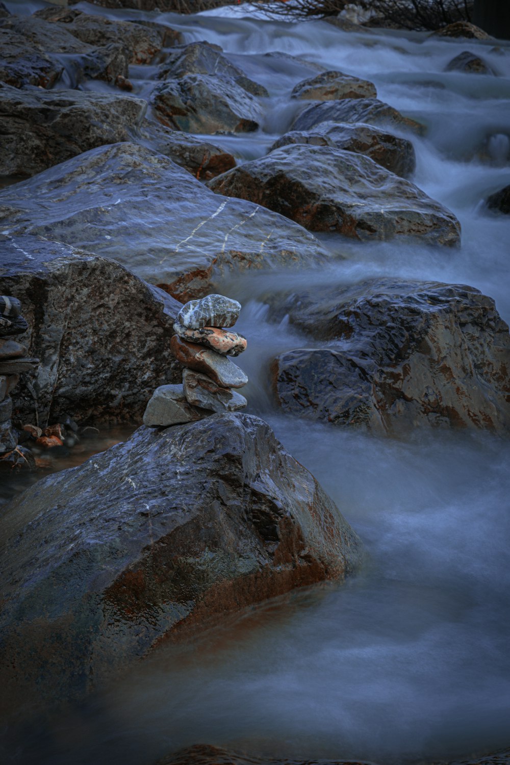 a stream of water flowing over rocks in a river