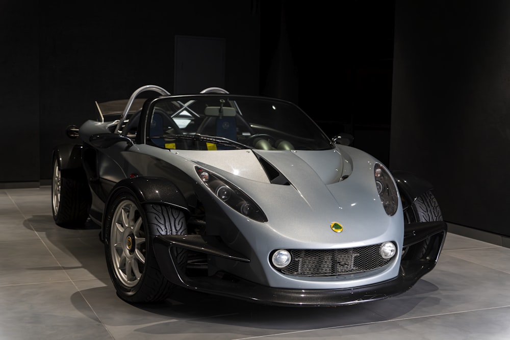 a silver and black sports car on display at a car show