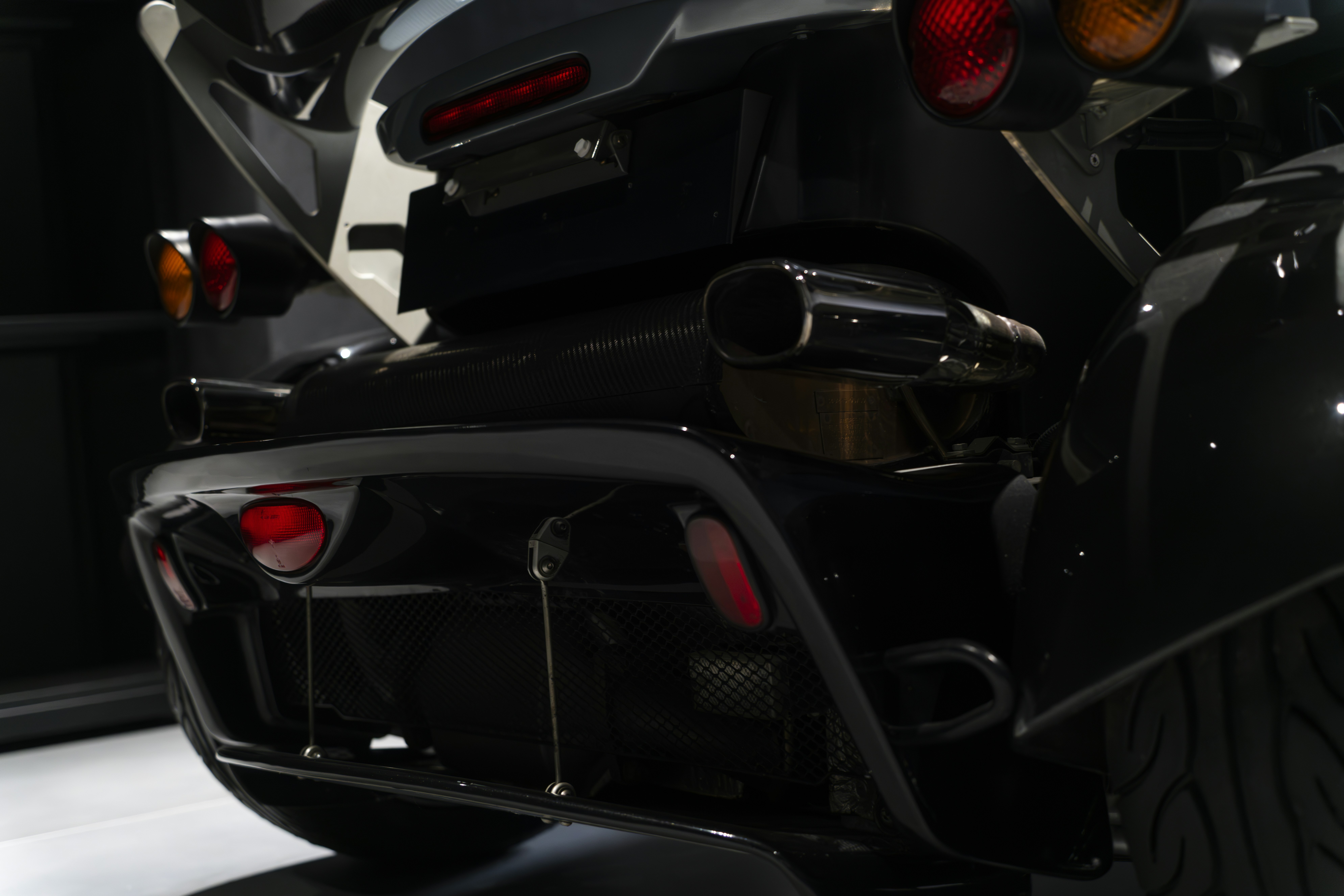 the rear end of a motorcycle parked in a garage