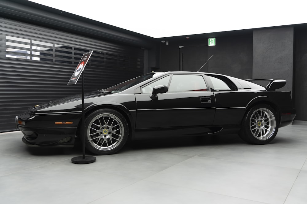 a black sports car parked in a garage