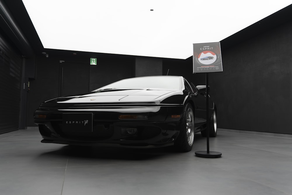 a black sports car parked in a parking garage