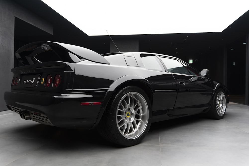 a black sports car parked in a garage