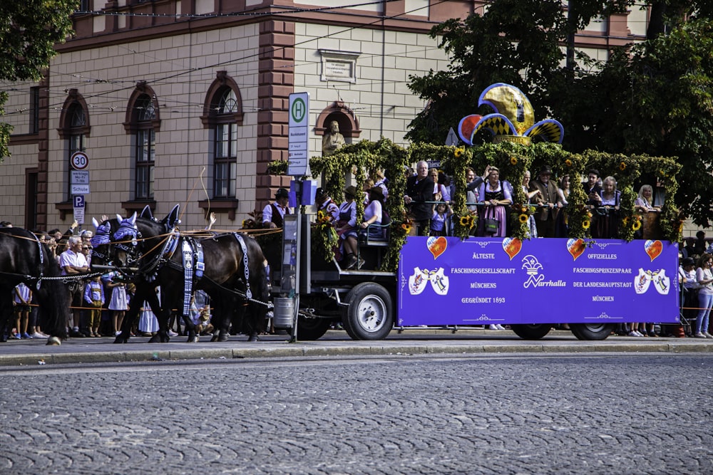 a horse drawn carriage carrying a large group of people