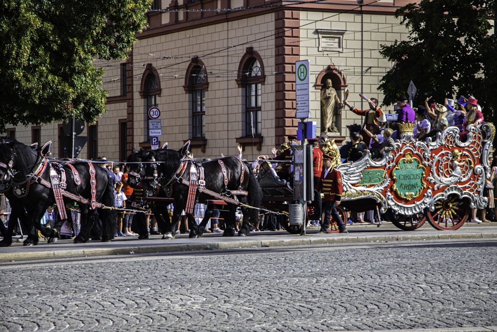 a group of people riding in a horse drawn carriage