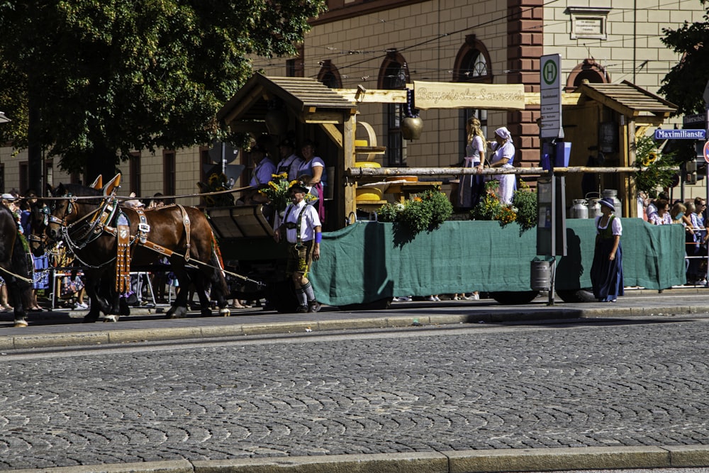 a group of people riding on the back of a horse drawn carriage