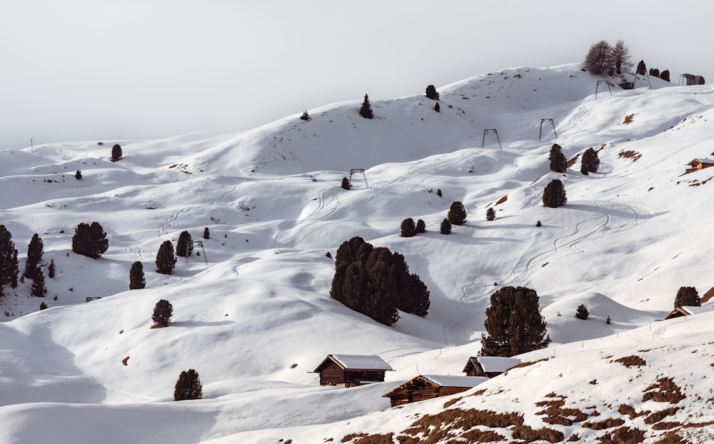 a snow covered mountain with a small cabin on top of it