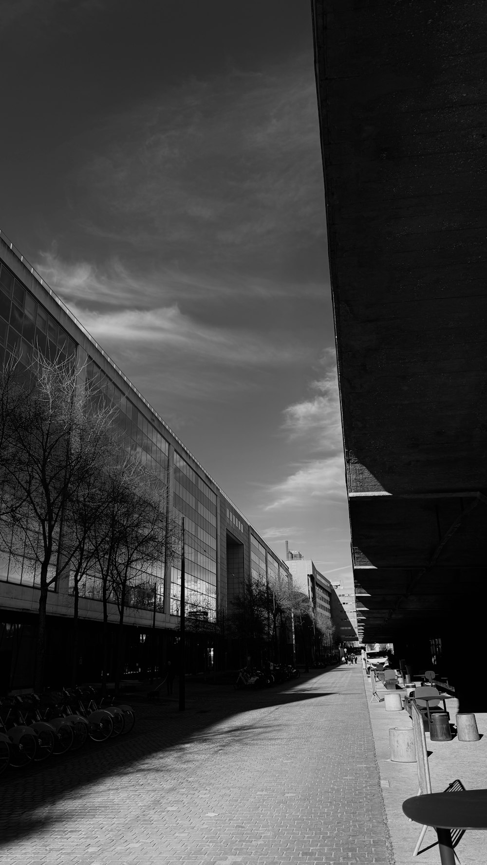 a black and white photo of a building and benches