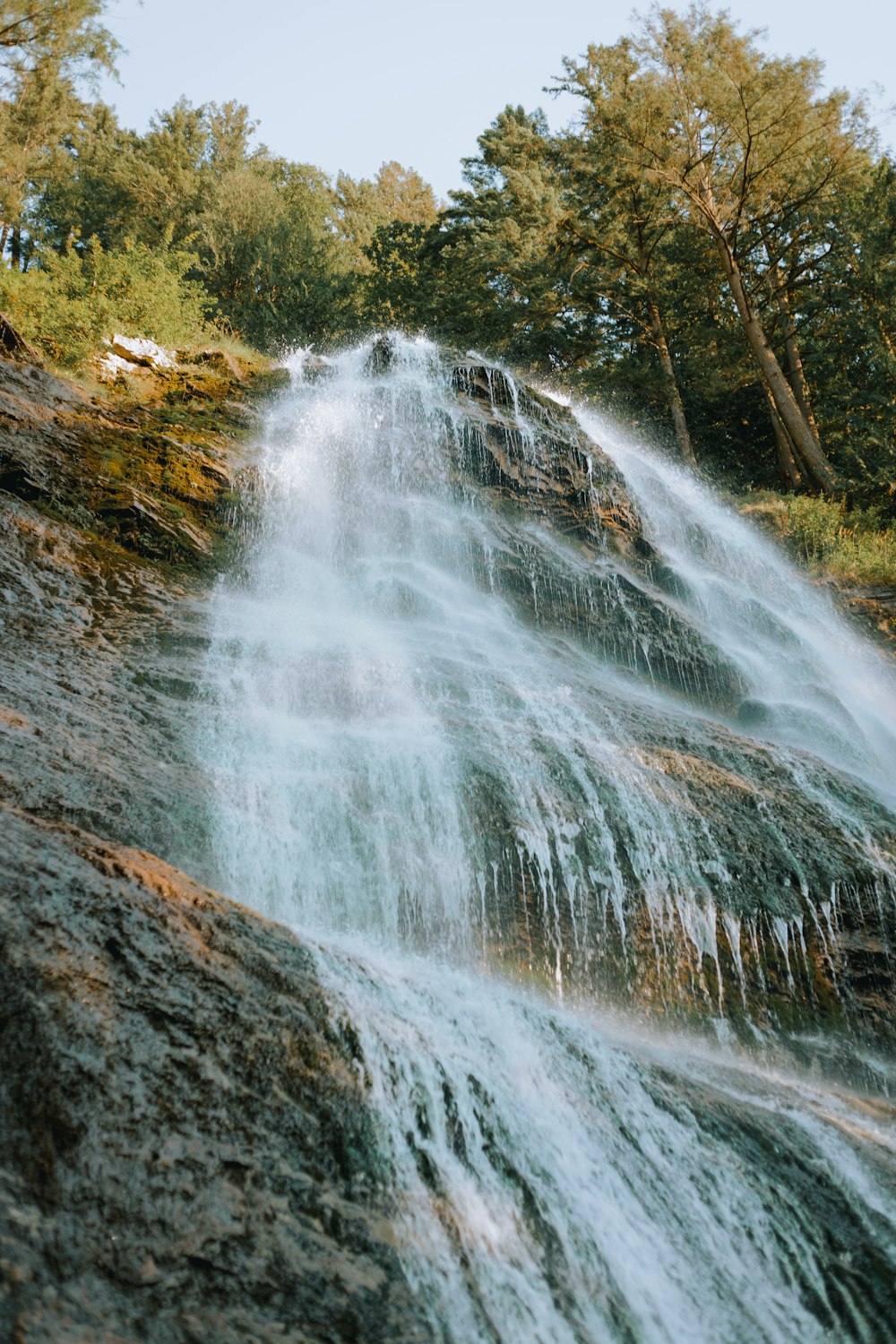 a very tall waterfall with lots of water coming out of it