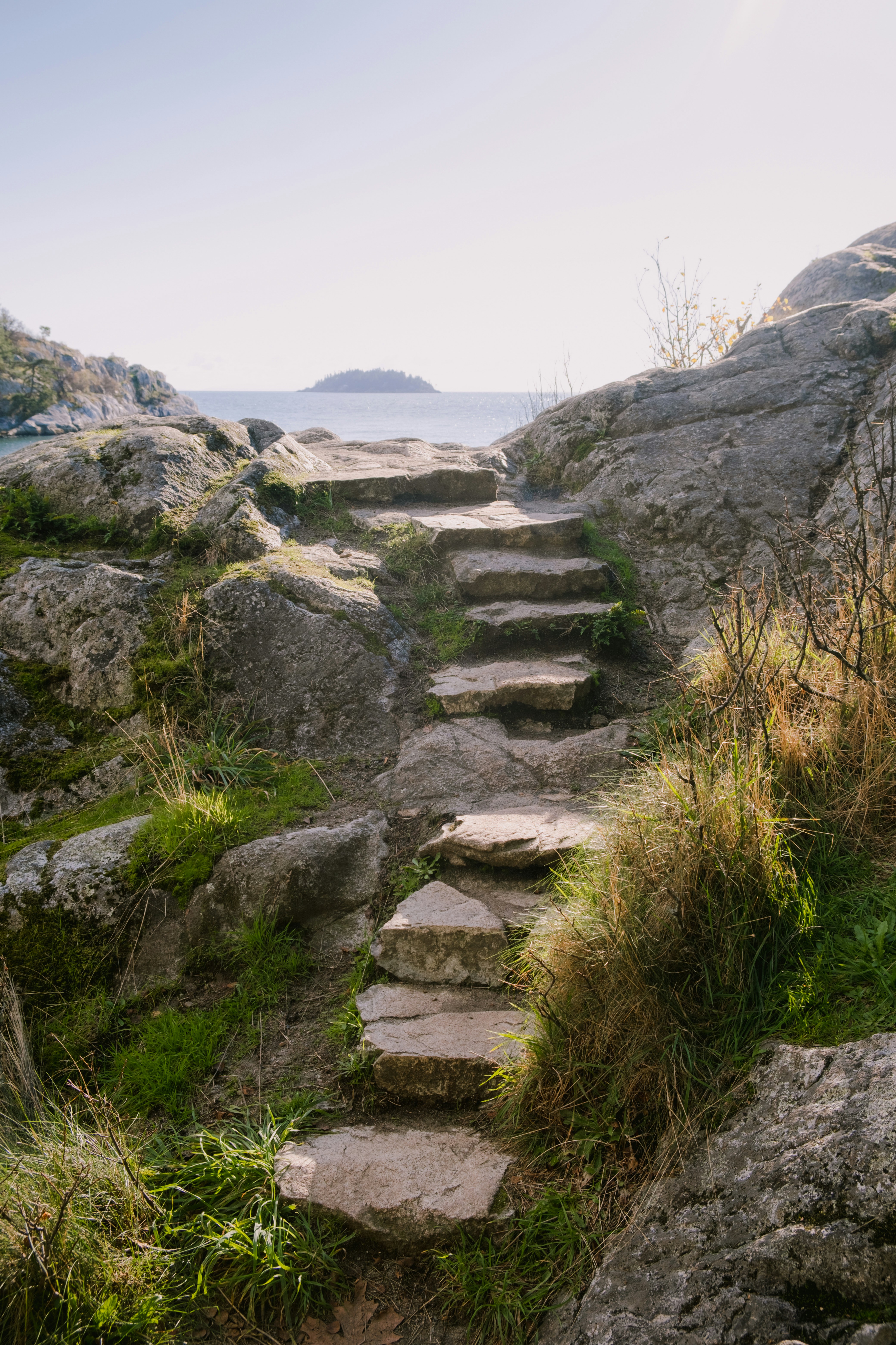 a set of stone steps leading to the ocean