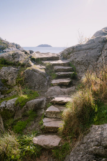 a set of stone steps leading to the ocean