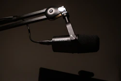 a close up of a microphone with a black background