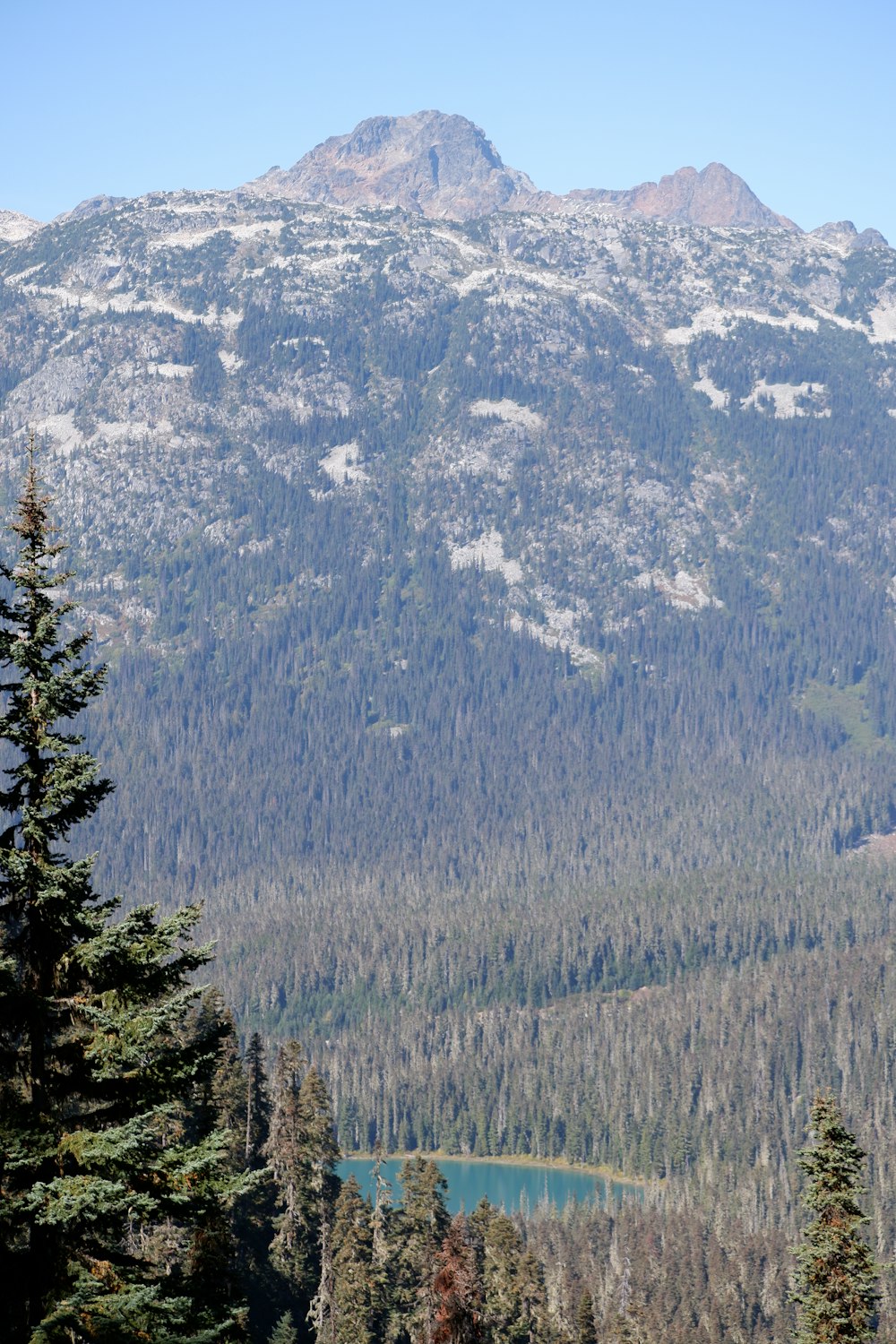 a view of a mountain range with a lake in the foreground