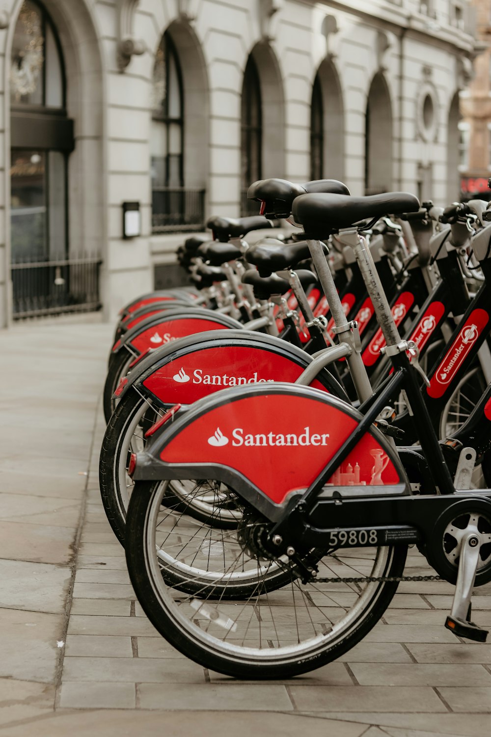 a row of bicycles parked next to each other on a sidewalk