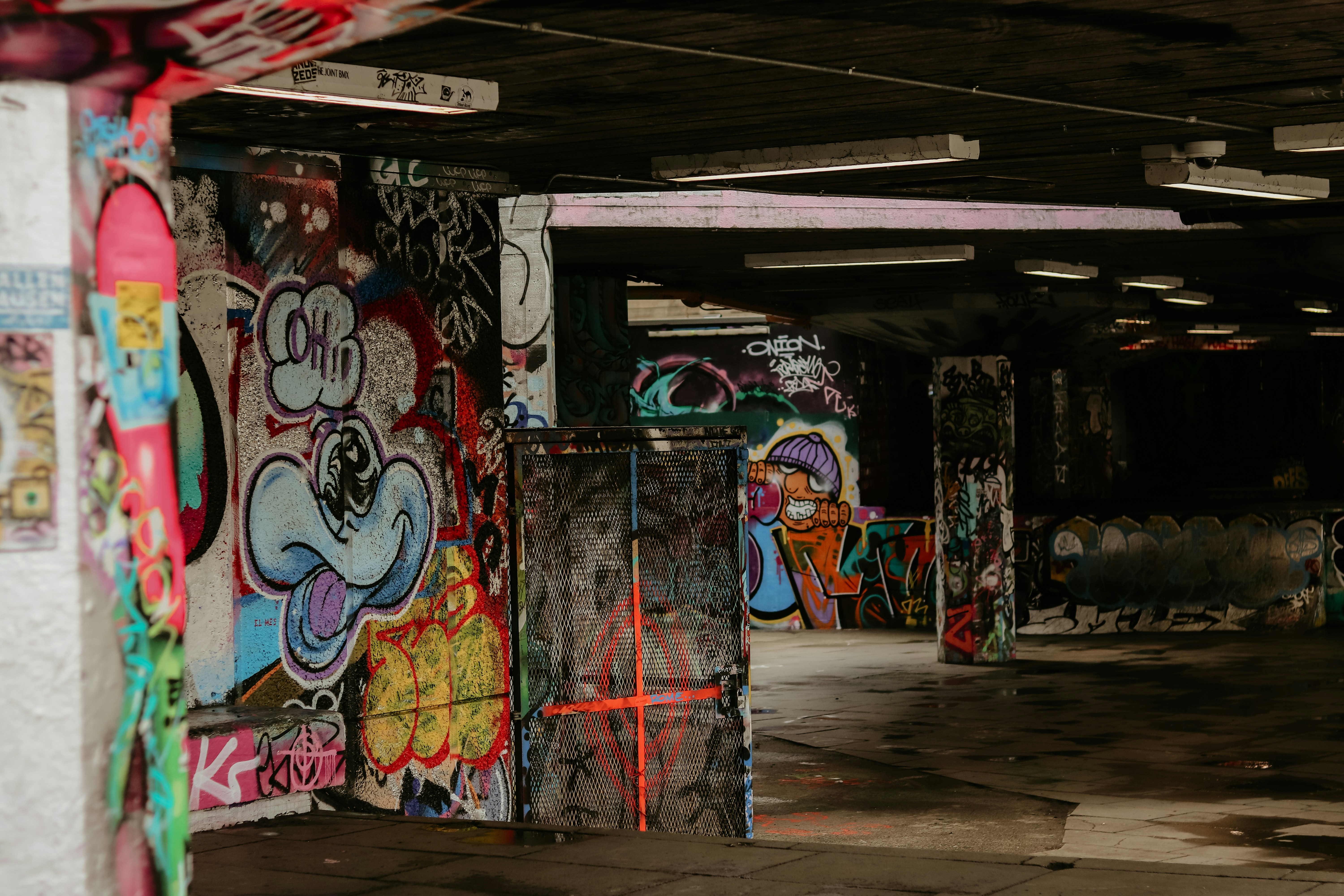 A parking garage with graffiti all over the walls photo Free Art
