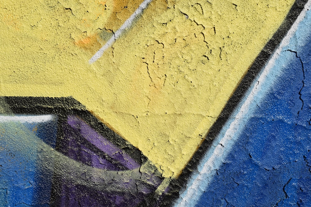 a close up of a yellow and blue wall