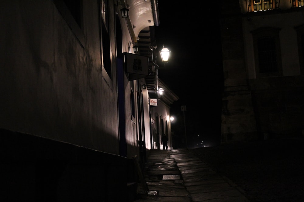 a dark street at night with a light on