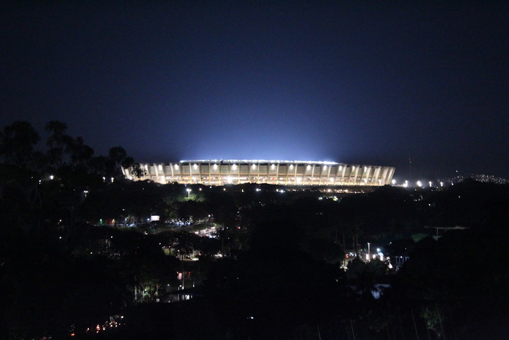 a stadium lit up at night with lights on