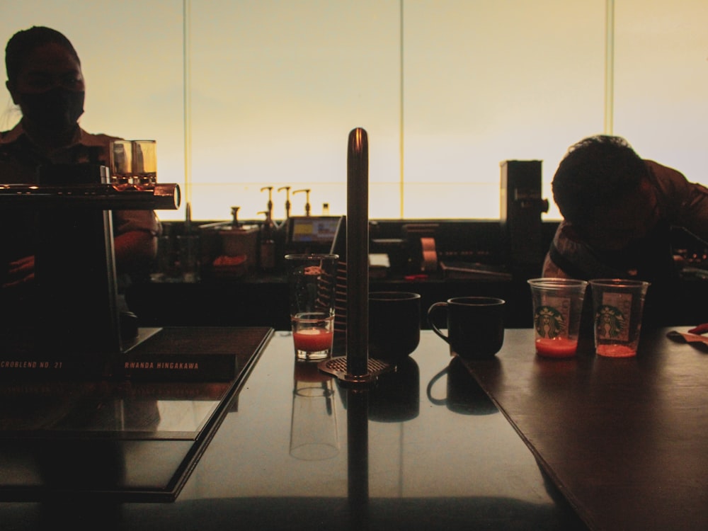 a man sitting at a table in front of a window