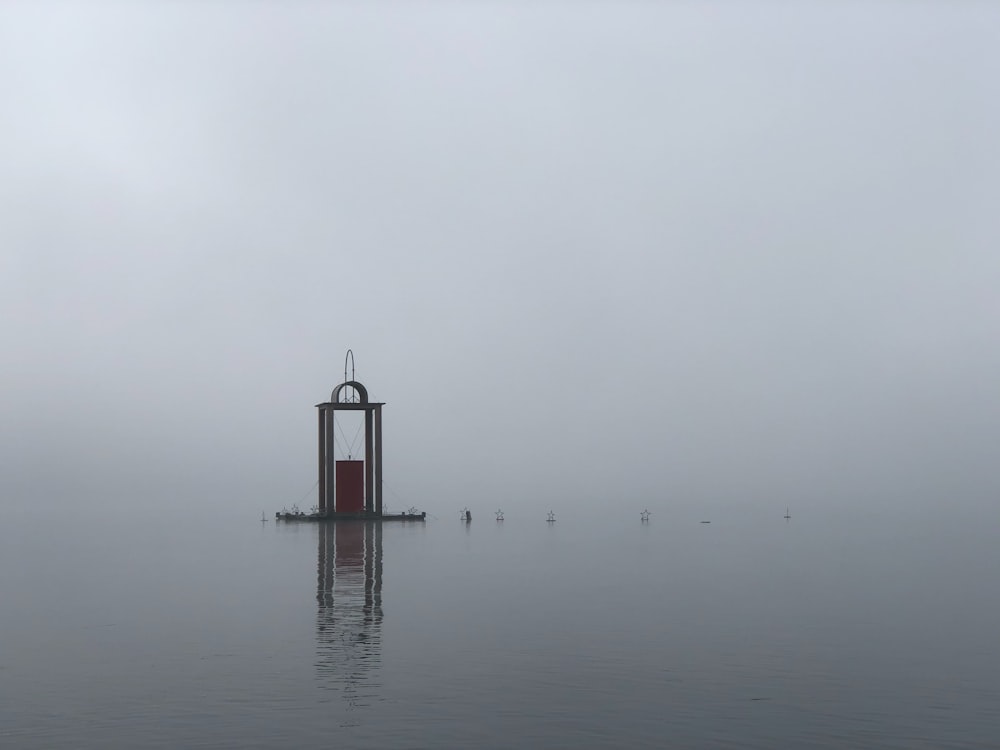 a clock tower in the middle of a body of water