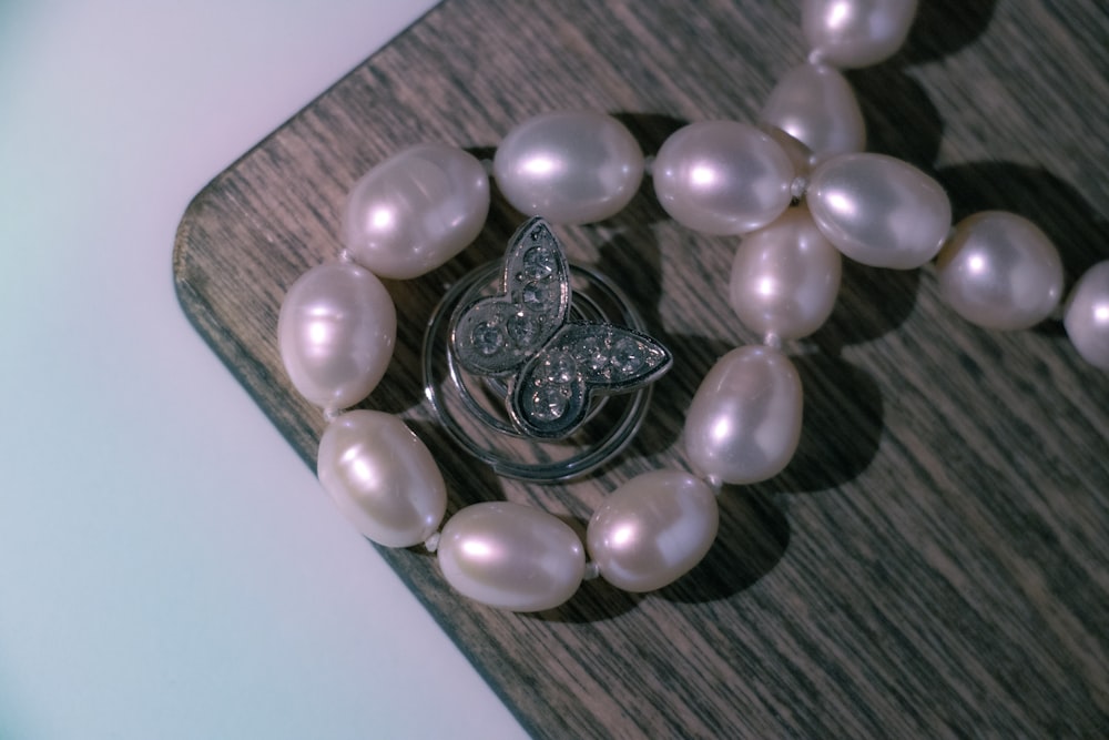 a close up of pearls and a brooch
