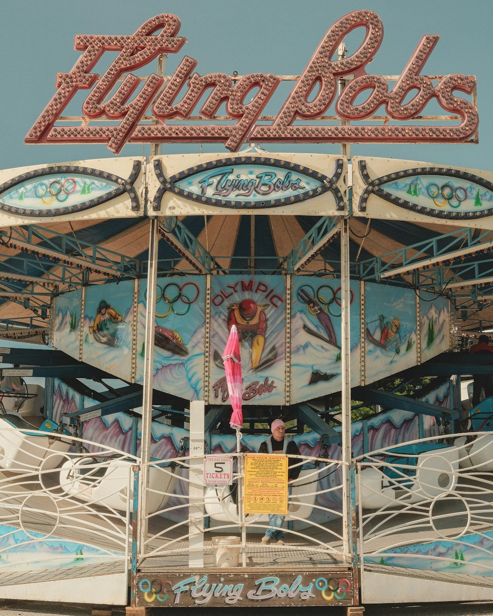 a carousel with a woman standing on top of it