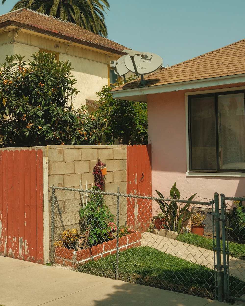 a house with a fence and a clock on the top of it