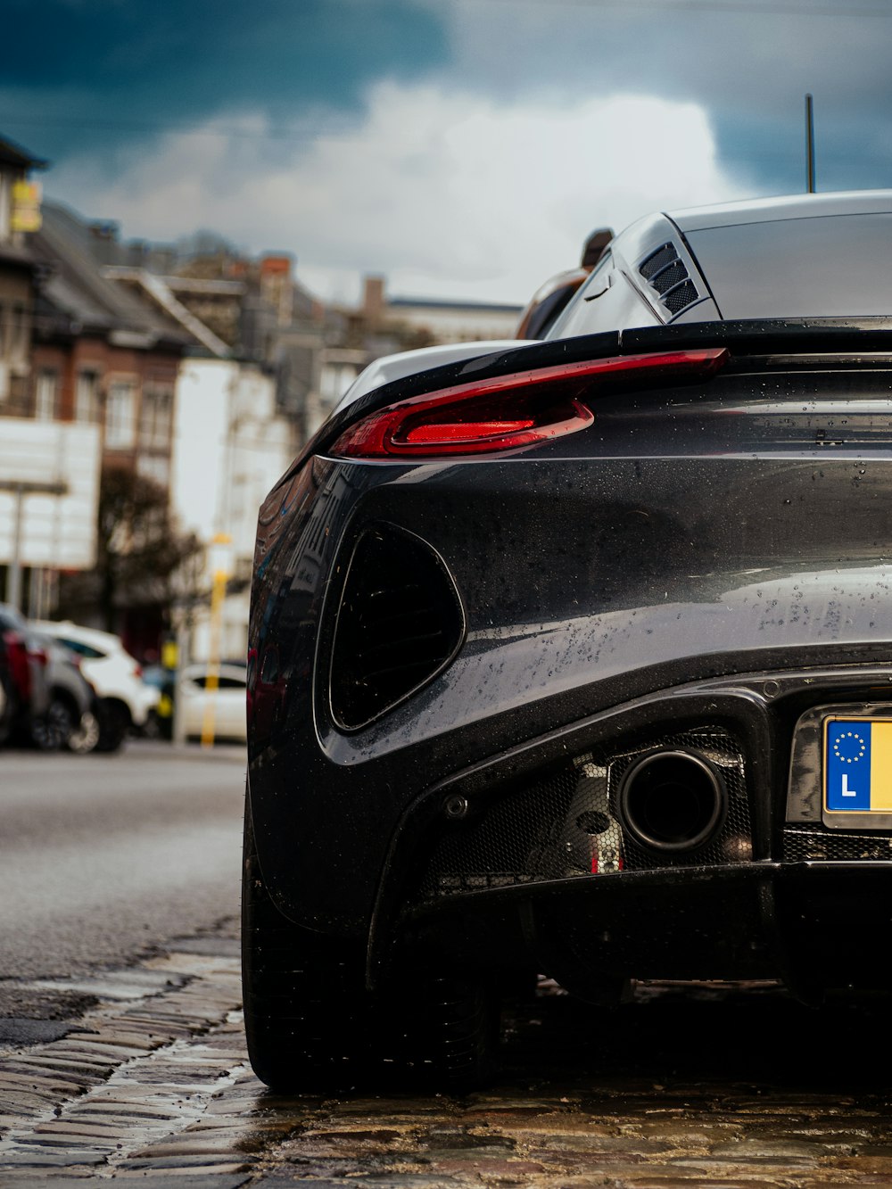 a black sports car parked on the side of the road