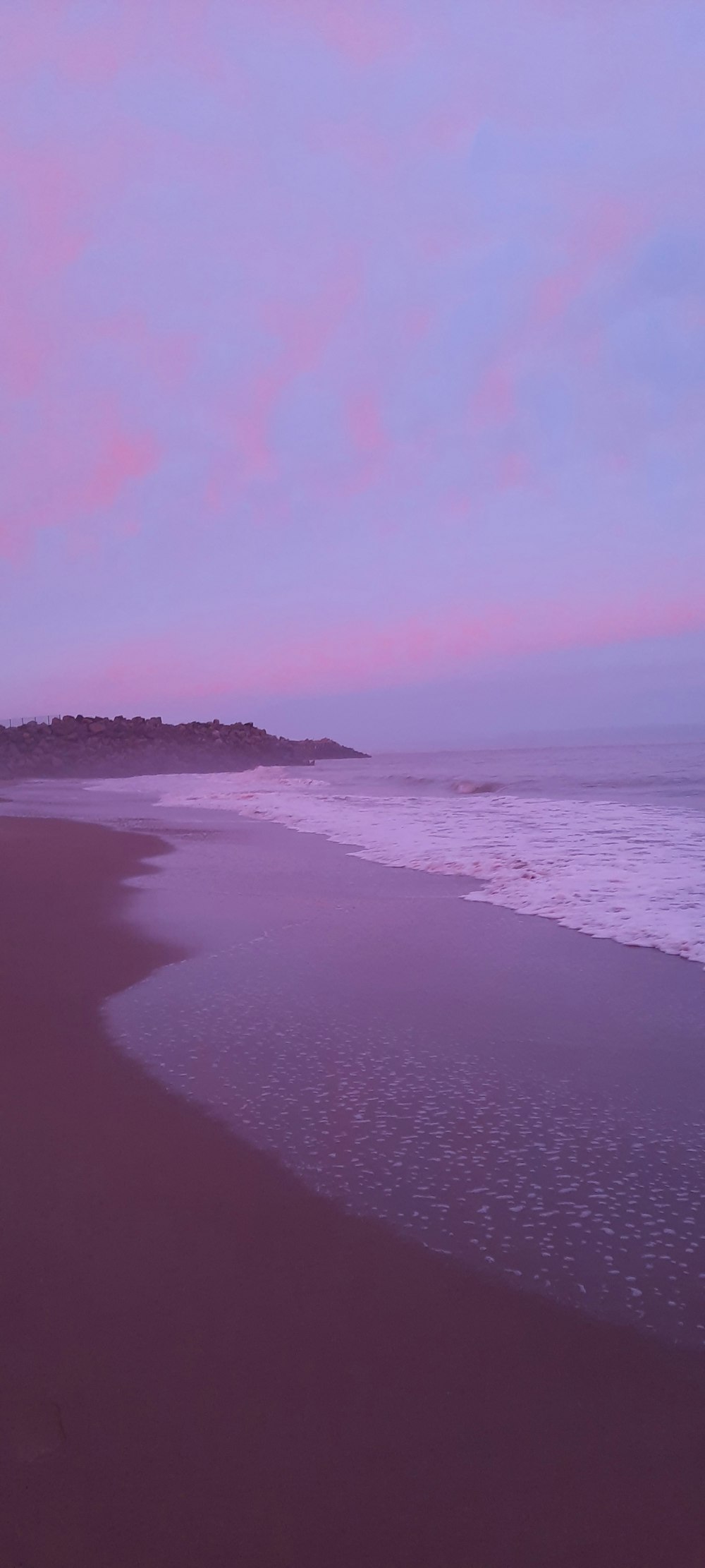 a beach with waves coming in to the shore