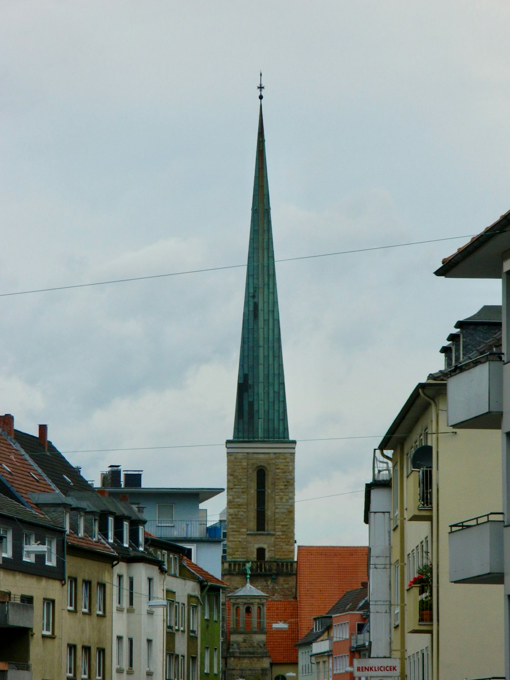 a church steeple towering over a city street