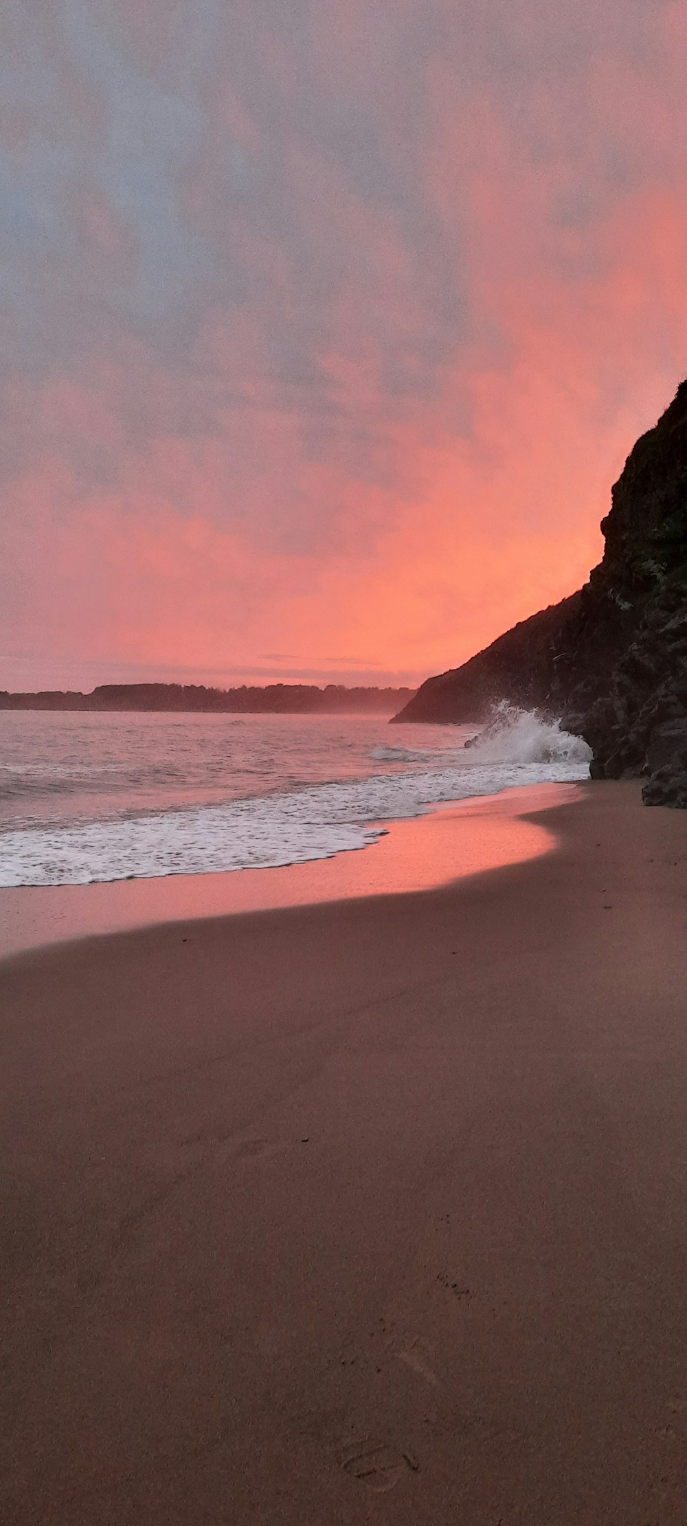 a beach with waves coming in to shore