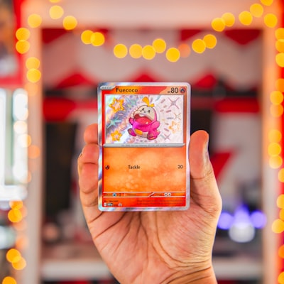 Person holding Pokemon card in store
