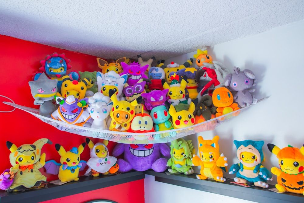 a bunch of stuffed animals are on a shelf