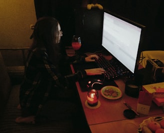 a person sitting at a desk with a computer