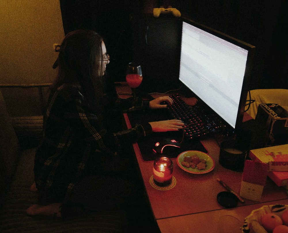 a person sitting at a desk with a computer
